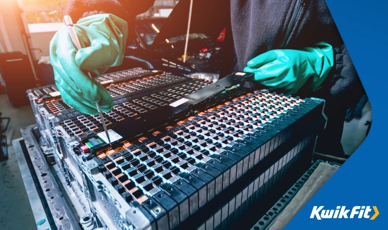 Battery technician checking individual cells for faults in a large lithium ion bank � commonly used with new EVs.