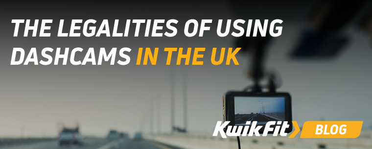 A dashcams hanging from the rearview mirror